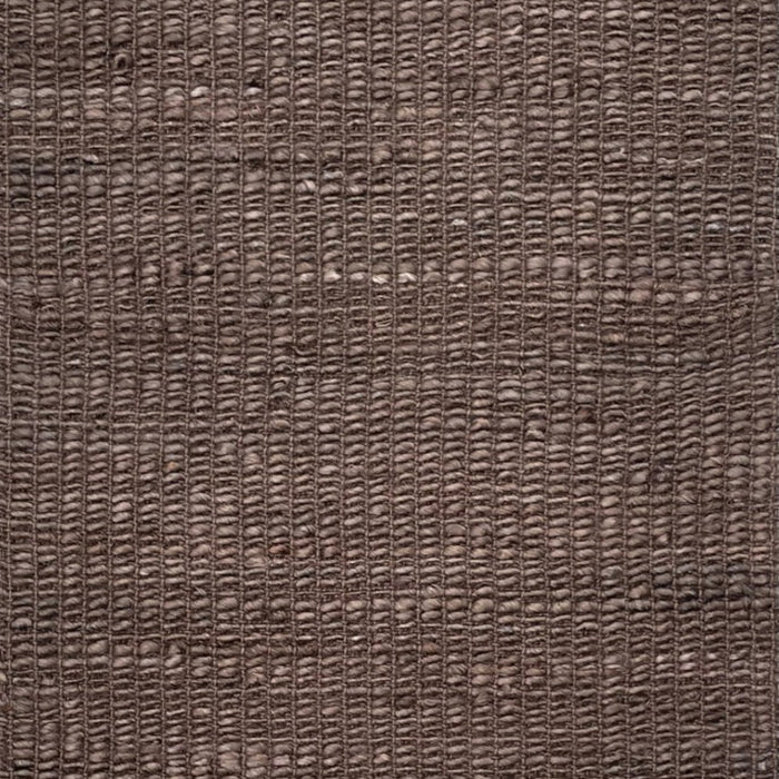 A close-up of a woven brown rug or textile with a textured, basketweave-like pattern filling the entire frame.
