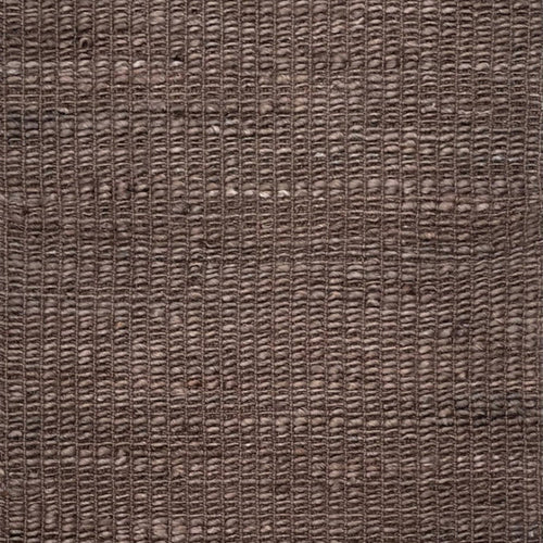 A close-up of a woven brown rug or textile with a textured, basketweave-like pattern filling the entire frame.