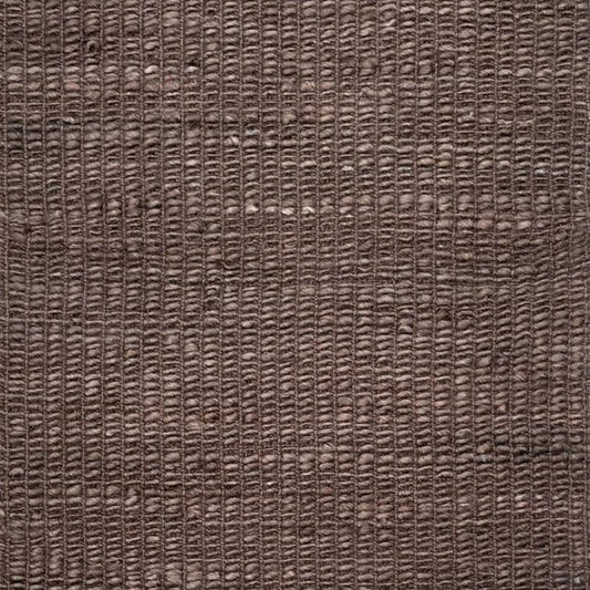 A close-up of a woven brown rug or textile with a textured, basketweave-like pattern filling the entire frame.
