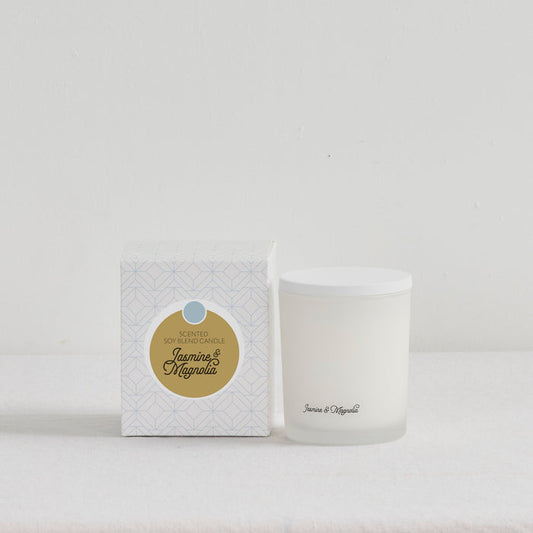 The Scent Collective Candle - Jasmine and Magnolia, white floral home fragrance candle beside patterned gift box