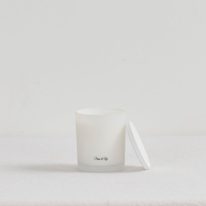 The Scent Collective Candle - Pear and Fig, white home fragrance candle with matching lid on a neutral surface