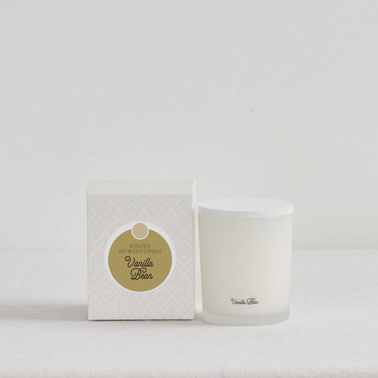 The Scent Collective Candle - Vanilla Bean, white scented soy candle with patterned gift box on a neutral surface