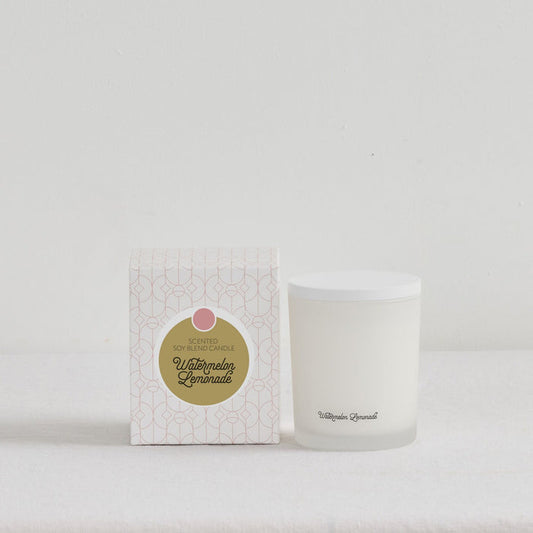 The Scent Collective Candle - Watermelon Lemonade, white home fragrance candle beside patterned gift box on a neutral surface