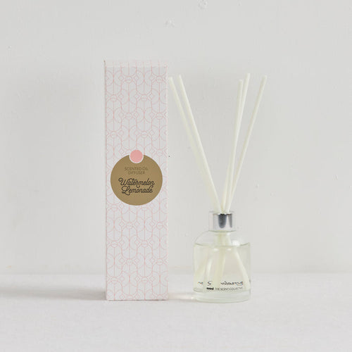 The Scent Collective Diffuser - Watermelon Lemonade, clear glass reed diffuser with pale fragrance oil and patterned box