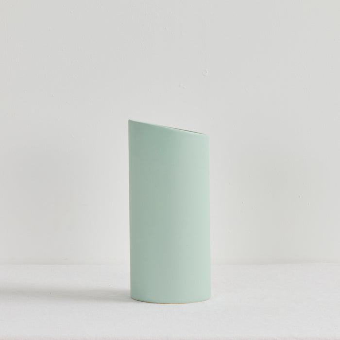 Light green cylindrical vase on a white background