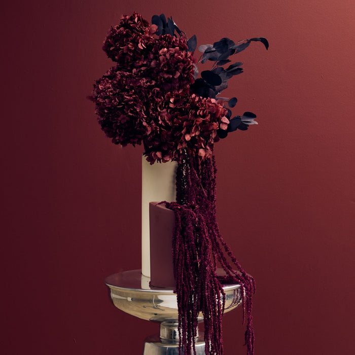 Tubular Small Vase - Port ceramic vase styled with dramatic dried burgundy flowers on a brass side table