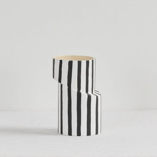 Twist Striped Medium Vase - White/Black, sculptural ceramic vase with bold vertical black stripes and an offset silhouette.