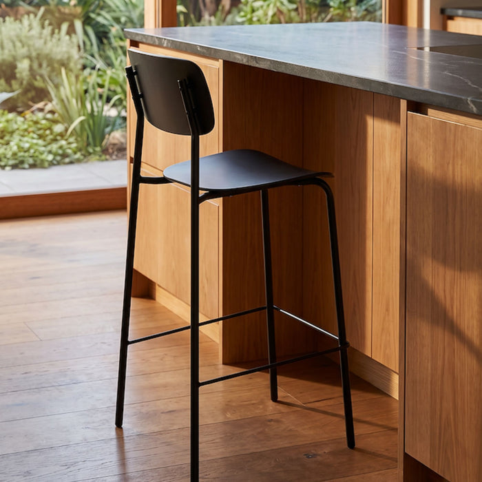 Vincent Counter Stool - Black with streamlined seat and backrest on slender black metal legs and footrest.