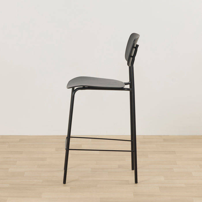 Vincent Counter Stool - Black side view with slim metal frame, curved backrest and footrest.