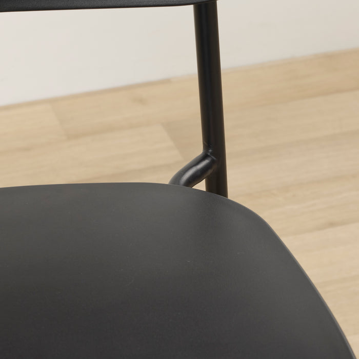 Vincent Counter Stool - Black close-up of black curved seat and slim metal frame detail.