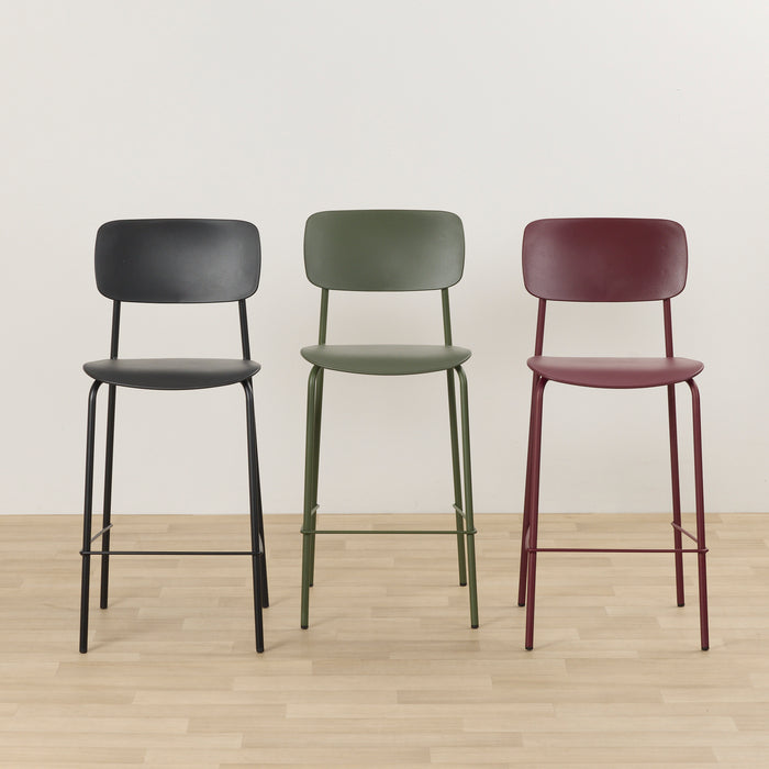 Vincent Counter Stool - Wine, burgundy counter stool with curved backrest and footrest, shown beside black and green stools.
