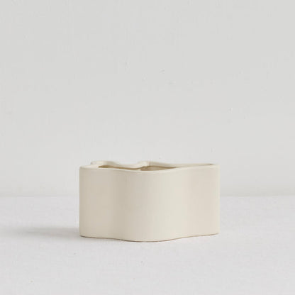Wave Low Vase - Bone, low sculptural ceramic vase with a softly undulating curved form and matte bone finish